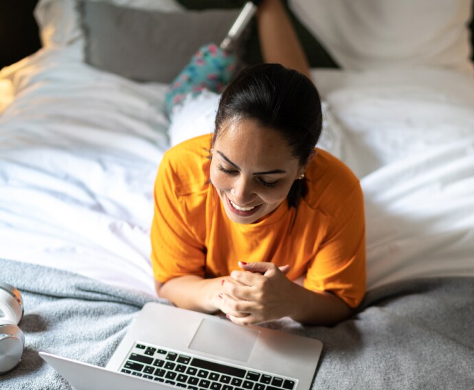 orange shirt woman lying-in bed.